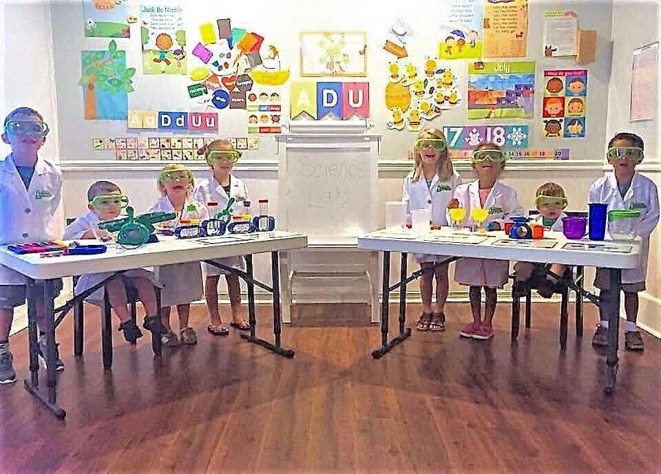 Children singing and moving during circle time at Kiddie Care faith-based preschool