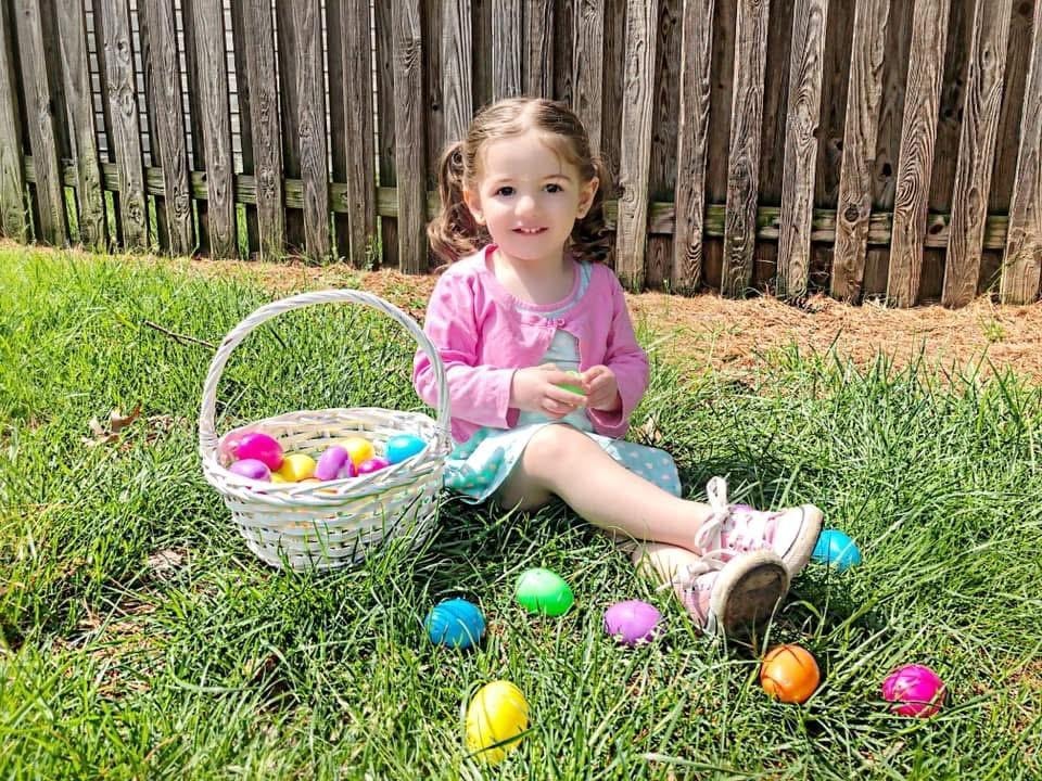 Girl with Easter basket in the yard at Kiddie Care Early Learning